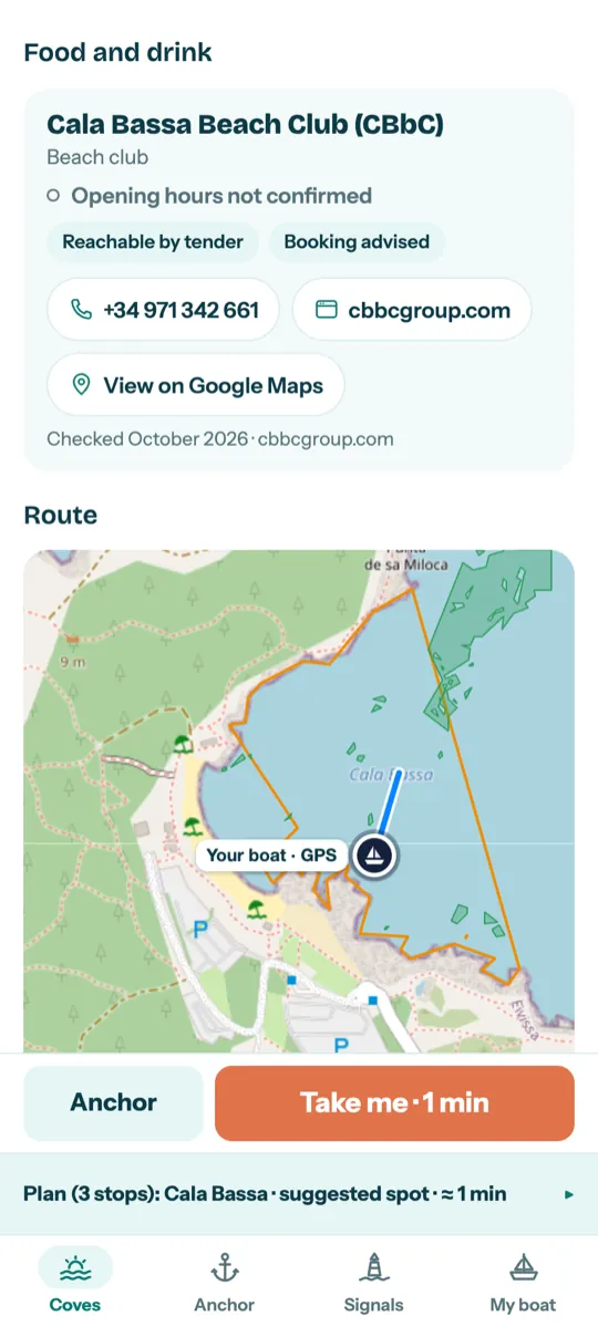Arena screenshot: Cala Bassa's beach club, reachable by tender, with phone and website, and the route to the anchoring spot